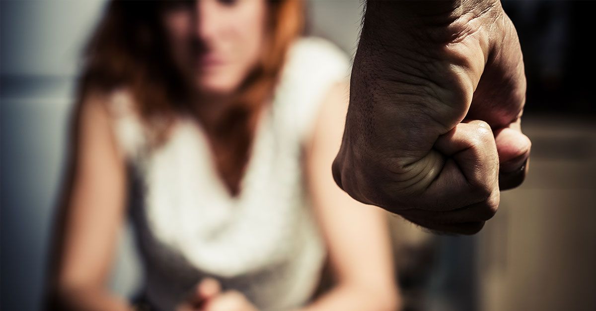 man clenching his fist in anger at his wife